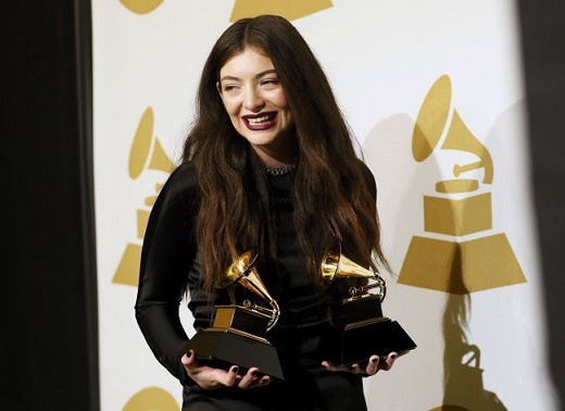 Lorde poses backstage with her awards at the 56th annual Grammy Awards in Los Angeles